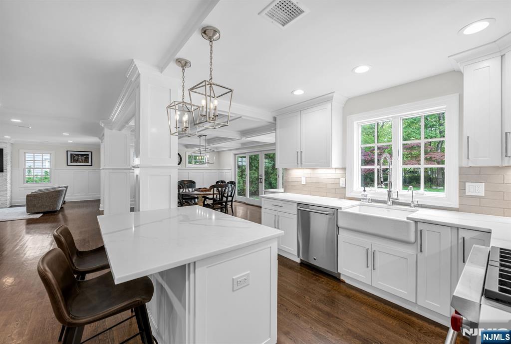 267 Merlin Place Wyckoff, NJ 07481 - Photo 20 of 49 a kitchen with a dining table chairs sink and wooden floor