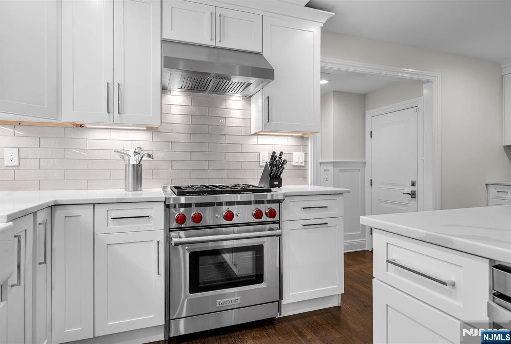 267 Merlin Place Wyckoff, NJ 07481 - Photo 22 of 49 a kitchen with white cabinets and white appliances