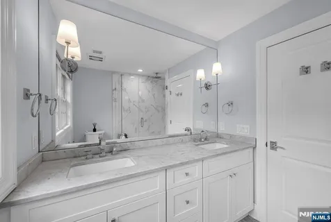 a bathroom with a toilet a sink and a mirror