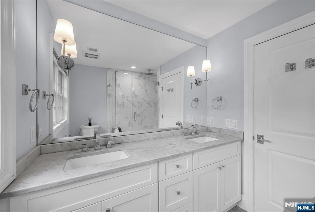 267 Merlin Place Wyckoff, NJ 07481 - Photo 31 of 49 a bathroom with a sink and a mirror