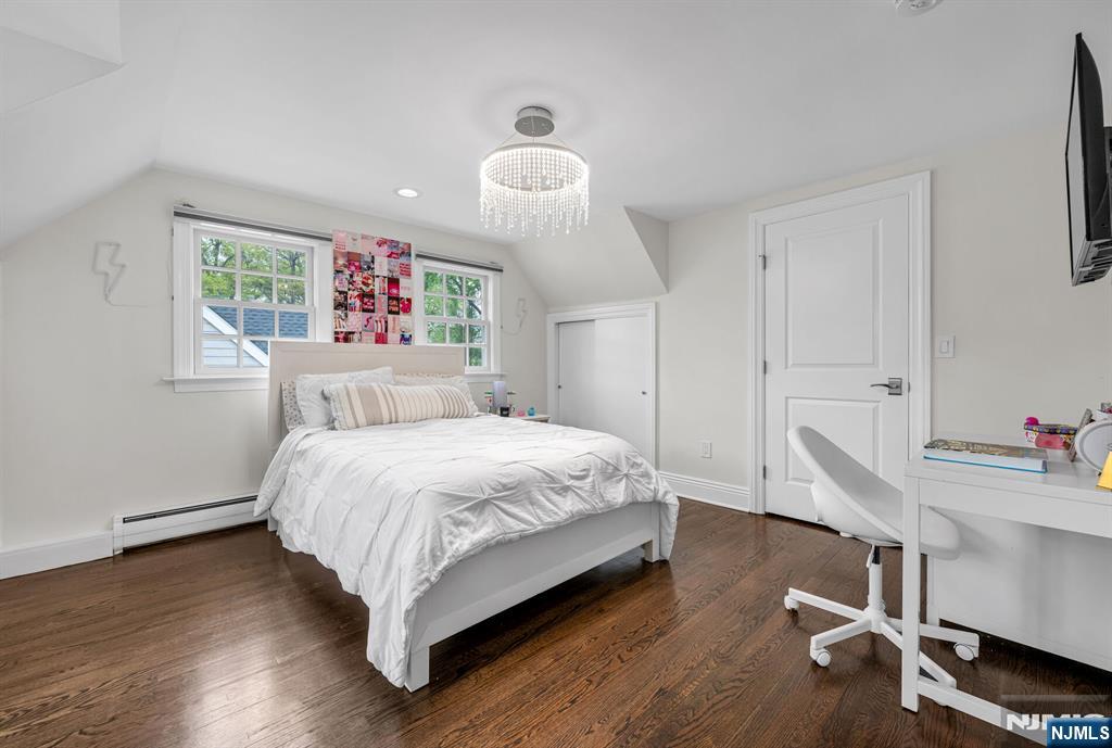 267 Merlin Place Wyckoff, NJ 07481 - Photo 33 of 49 a bedroom with a bed and a chandelier