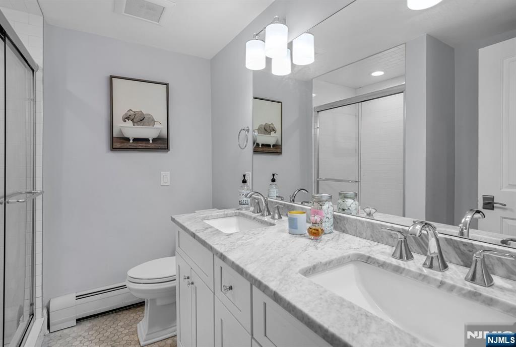 267 Merlin Place Wyckoff, NJ 07481 - Photo 35 of 49 a bathroom with a toilet a sink and a mirror