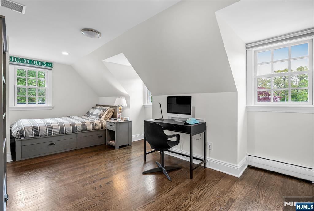 267 Merlin Place Wyckoff, NJ 07481 - Photo 36 of 49 a bedroom with a bed and a chair