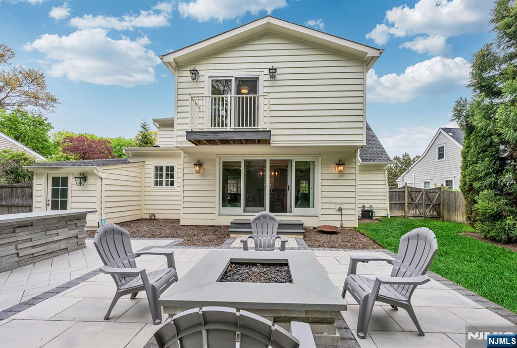 267 Merlin Place Wyckoff, NJ 07481 - Photo 43 of 49 a view of a patio with table and chairs with wooden floor and fence