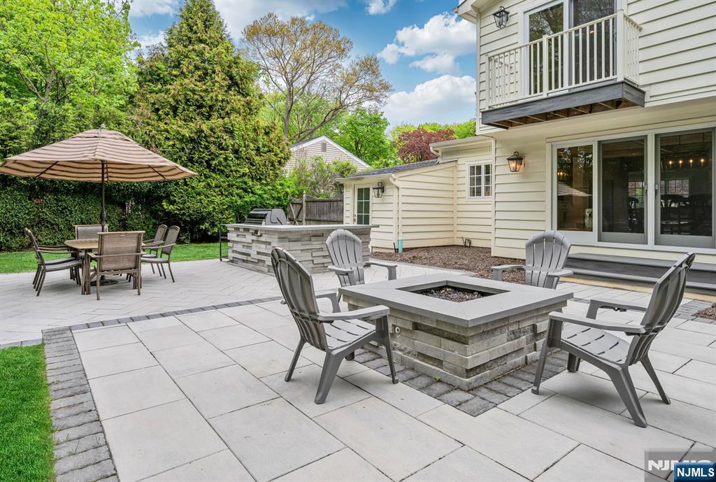267 Merlin Place Wyckoff, NJ 07481 - Photo 44 of 49 a backyard of a house with table and chairs