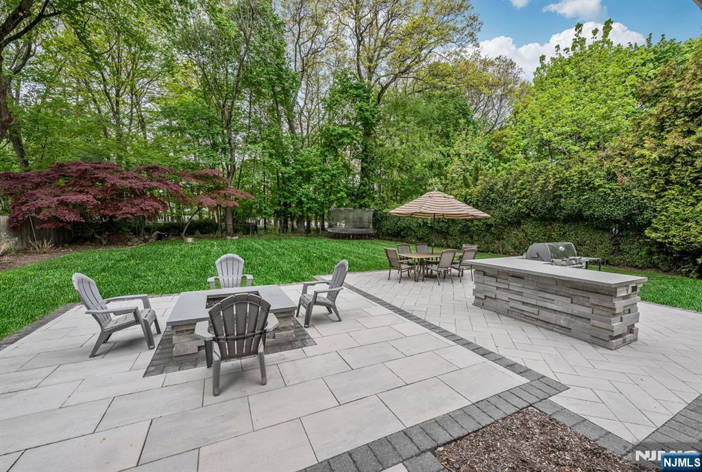 267 Merlin Place Wyckoff, NJ 07481 - Photo 45 of 49 a view of a table and chairs under an umbrella
