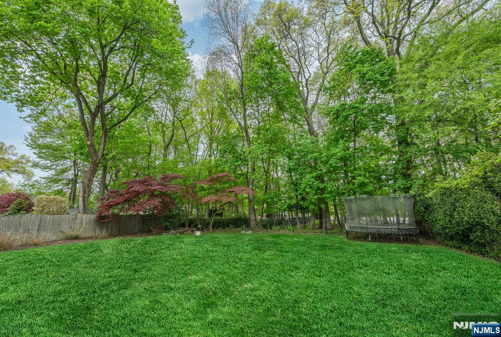 267 Merlin Place Wyckoff, NJ 07481 - Photo 47 of 49 a view of a backyard with potted plants and large trees