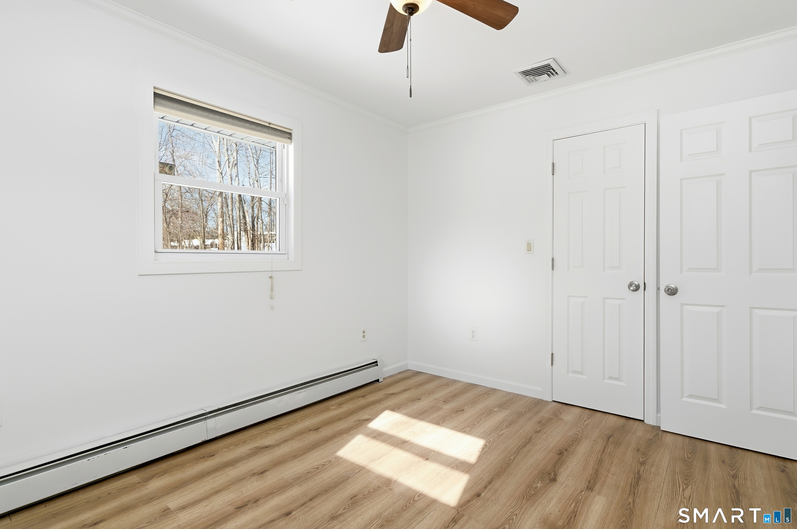 23 Ridgefield Road Wallingford, CT 06492 - Photo 19 of 28 a view of an empty room with wooden floor and a window