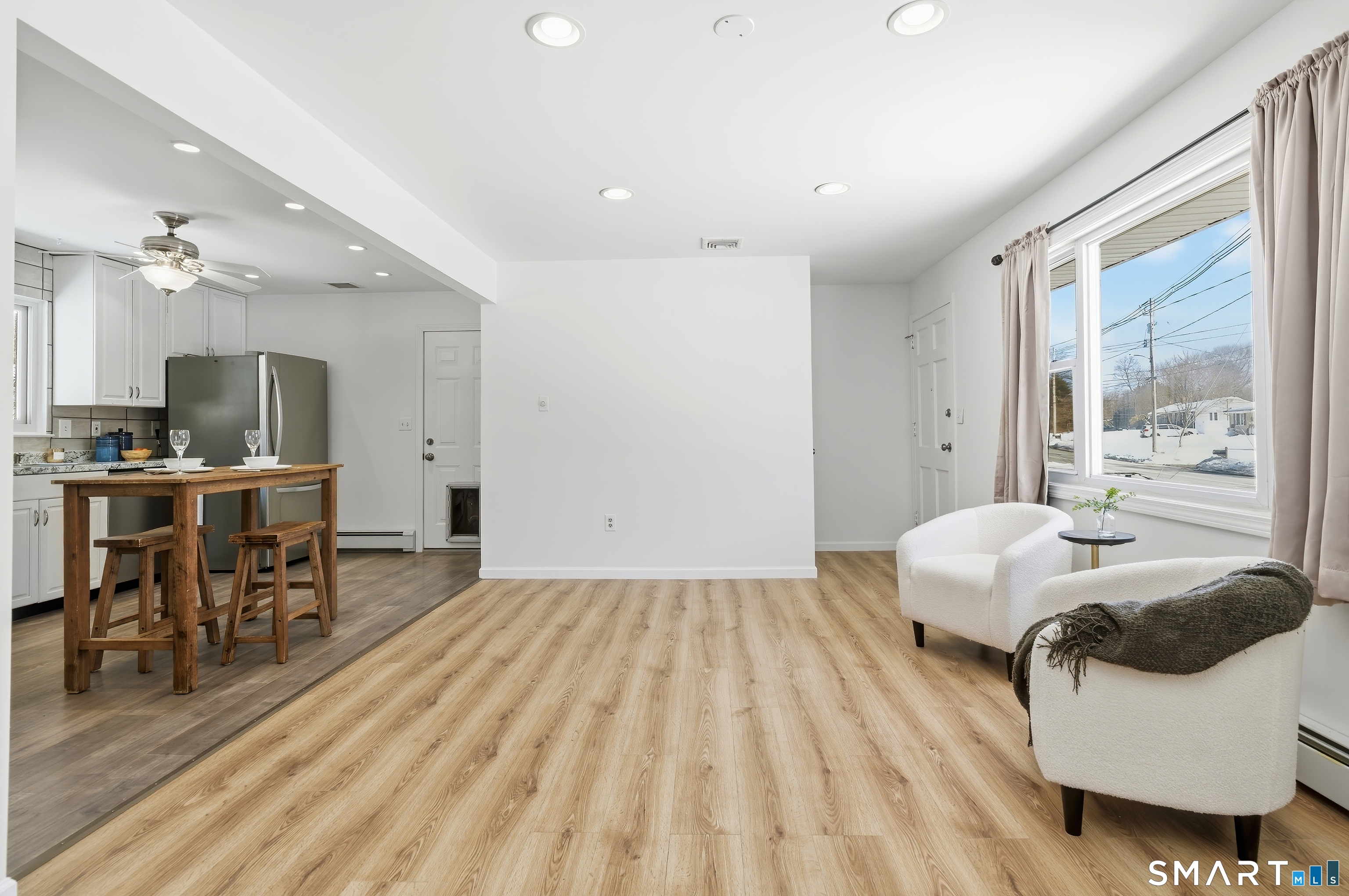 23 Ridgefield Road Wallingford, CT 06492 - Photo 10 of 28 a bedroom with a bed and a table with wooden floor