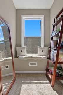 a view of living room with furniture and a book shelf