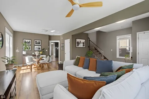 a living room with furniture and wooden floor
