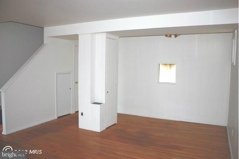210 Cove Road Essex, MD 21221 - Photo 11 of 11 a view of an empty room with wooden floor and a window