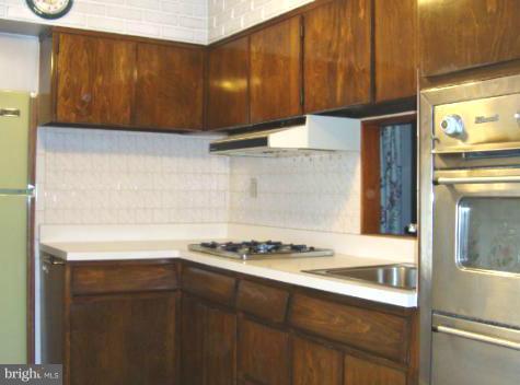 210 Cove Road Essex, MD 21221 - Photo 4 of 11 a kitchen with a stove and a refrigerator