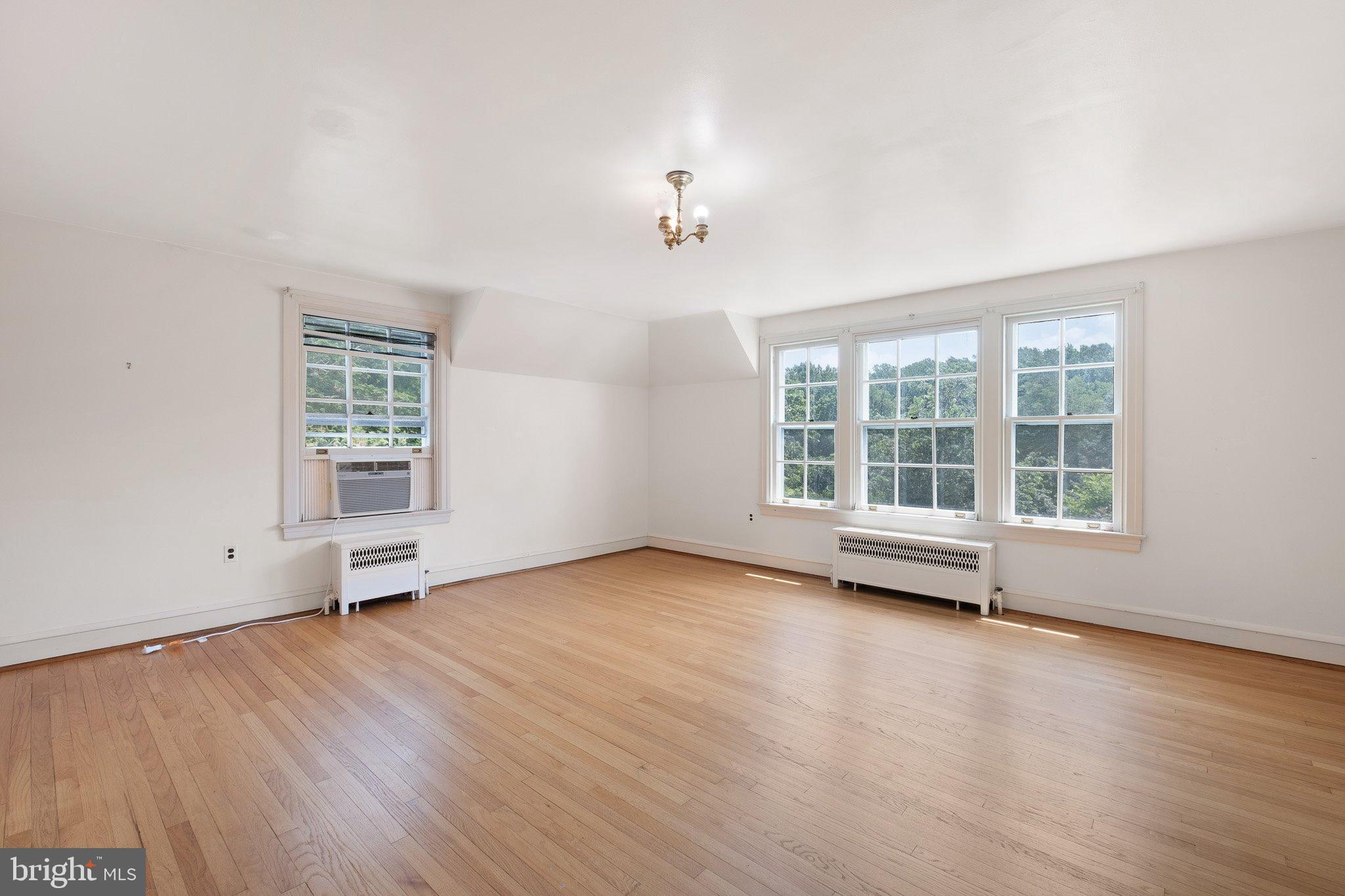 121 Gun Club Road Hockessin, DE 19707 - Photo 12 of 20 an empty room with wooden floor and windows