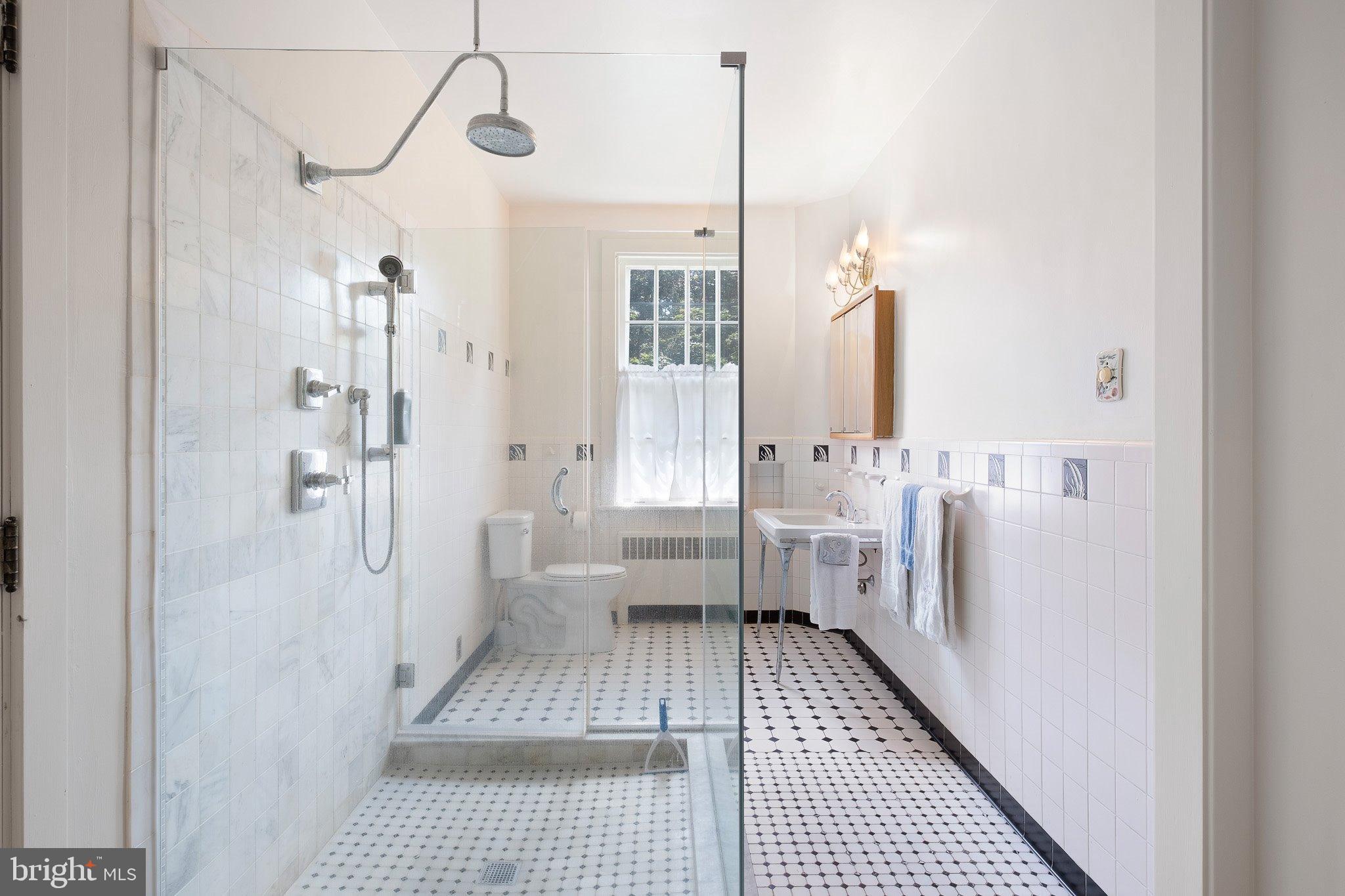 121 Gun Club Road Hockessin, DE 19707 - Photo 17 of 20 a bathroom with a sink a toilet and shower