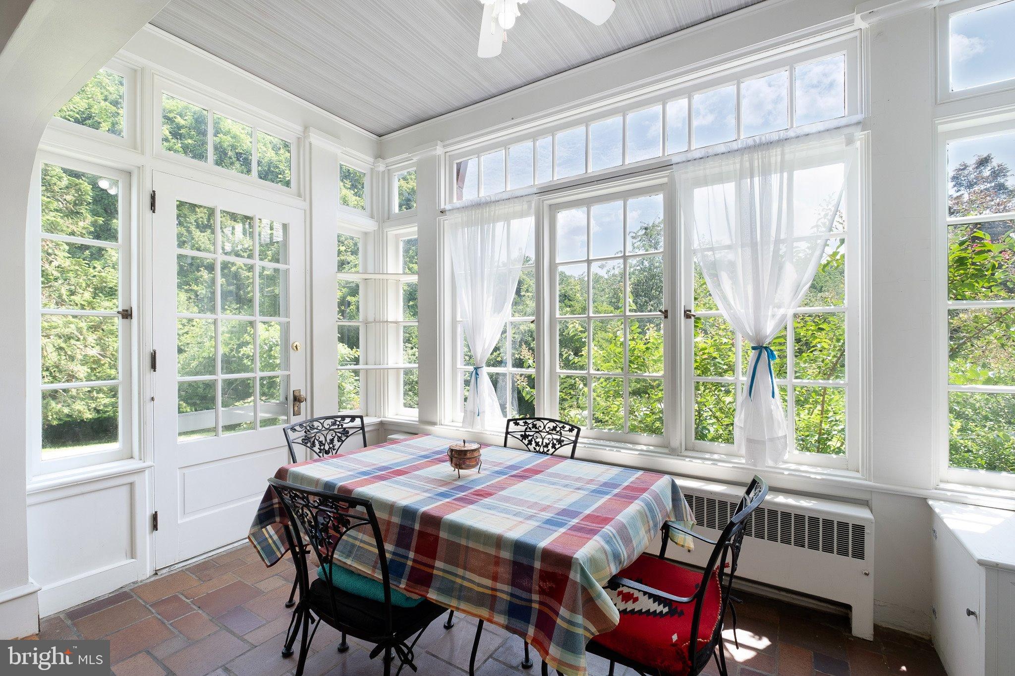 121 Gun Club Road Hockessin, DE 19707 - Photo 7 of 20 a view of a dining room with furniture large windows and wooden floor