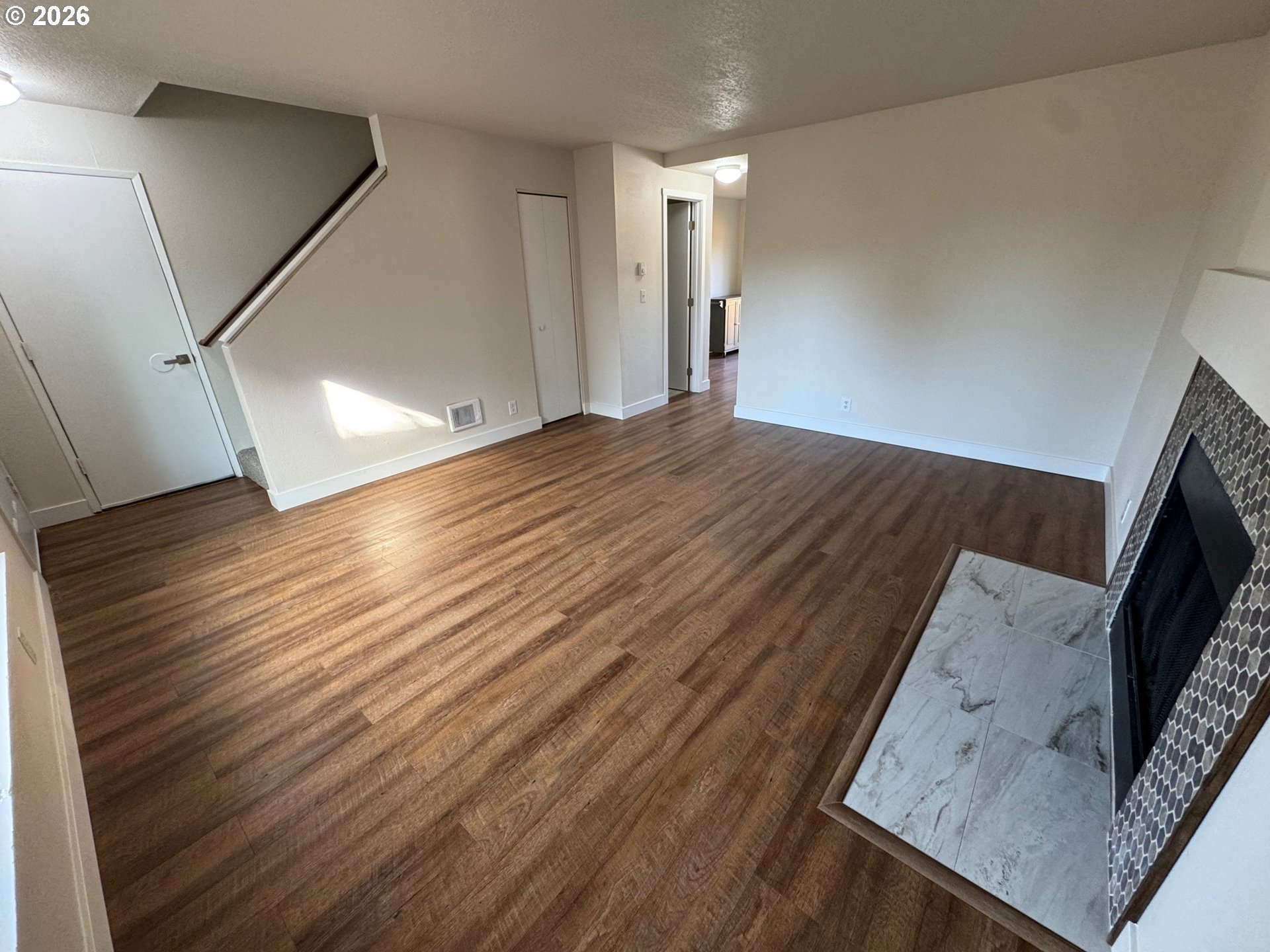 19901 Southwest Meadowbrook Court Beaverton, OR 97078 - Photo 5 of 23 a view of a hallway to a room with wooden floor
