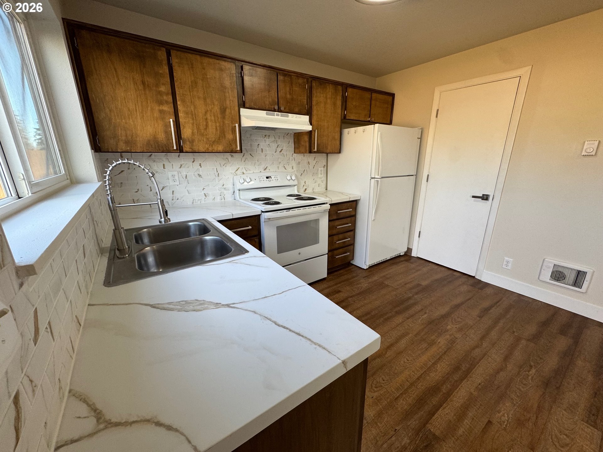 19901 Southwest Meadowbrook Court Beaverton, OR 97078 - Photo 9 of 23 a kitchen with a refrigerator sink and stove