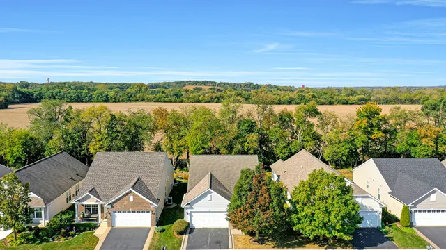 an aerial view of a house with a lake view