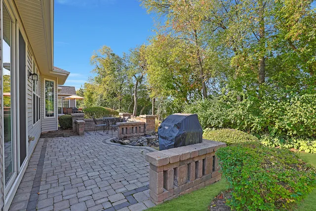 a view of a chairs and table in the back yard of the house