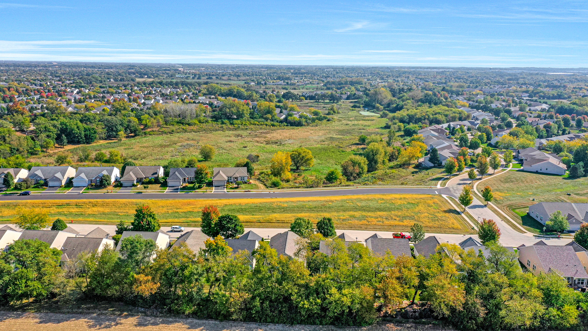 12669 Meritage Court Huntley, IL 60142 - Photo 29 of 33 an aerial view of residential houses with outdoor space and swimming pool