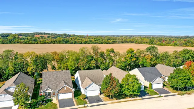 an aerial view of a house with a lake view