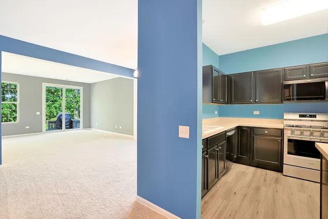 a kitchen with granite countertop a stove a sink and a microwave