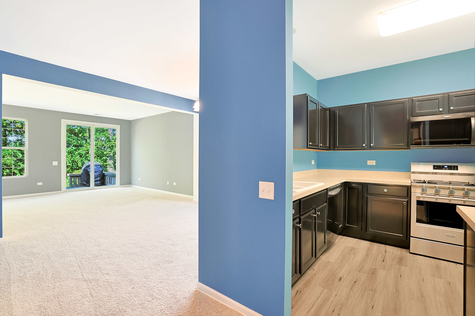 12669 Meritage Court Huntley, IL 60142 - Photo 3 of 33 a kitchen with granite countertop a stove a sink and a microwave