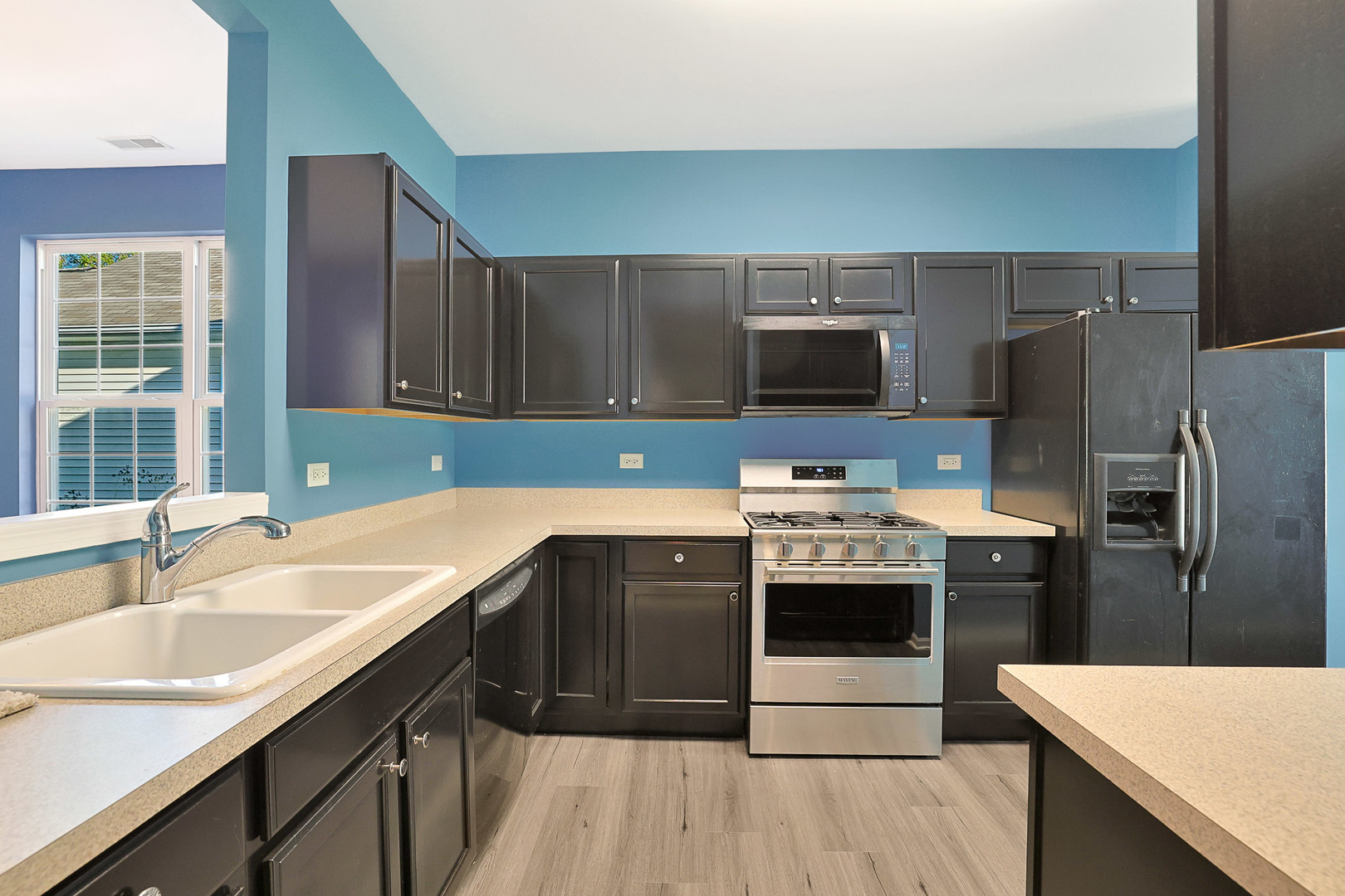 12669 Meritage Court Huntley, IL 60142 - Photo 4 of 33 a kitchen with stainless steel appliances a sink stove and refrigerator