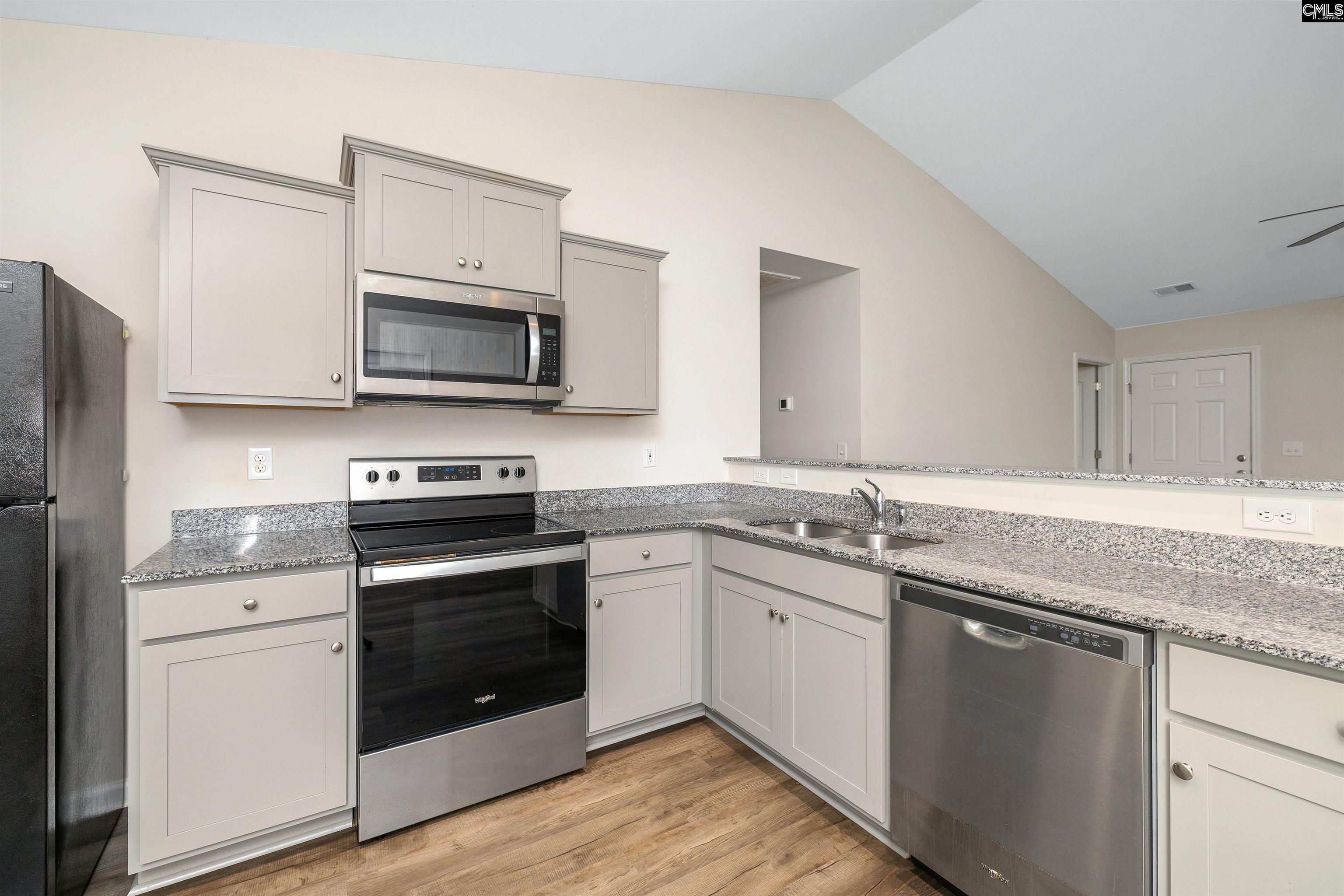 2157 Still Pointe Drive Sumter, SC 29154 - Photo 13 of 25 a kitchen with stainless steel appliances granite countertop a stove microwave and sink