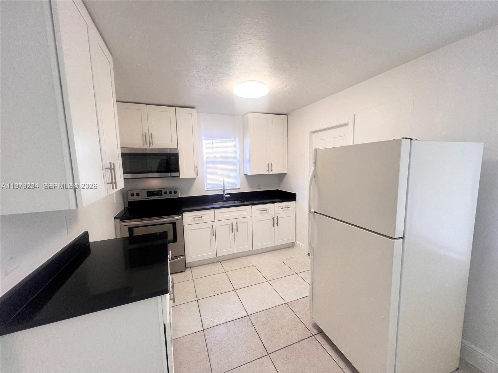 5600 Northwest 15th Street, Unit 9 Lauderhill, FL 33313 - Photo 1 of 7 a white refrigerator freezer sitting in a kitchen