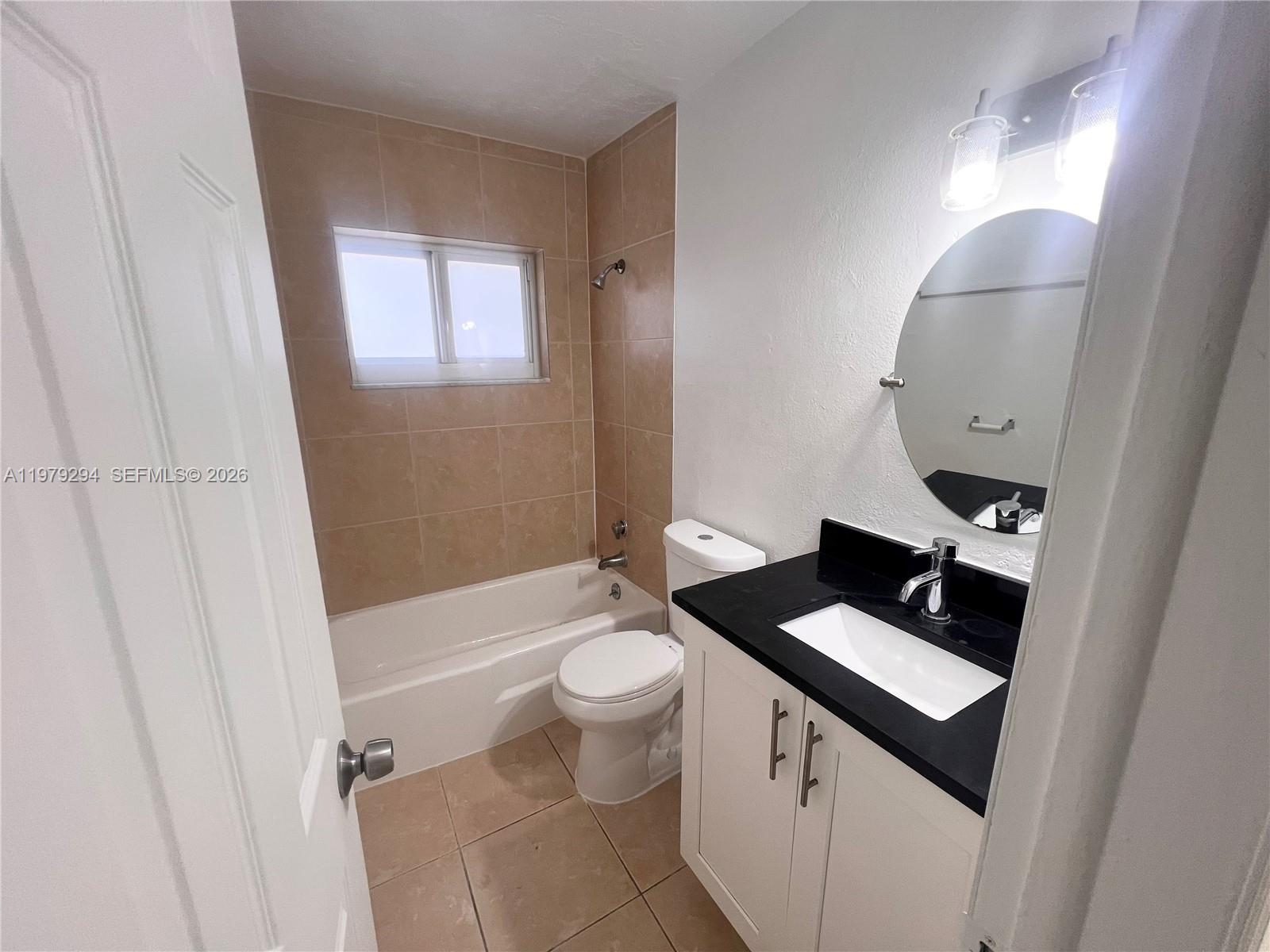 5600 Northwest 15th Street, Unit 9 Lauderhill, FL 33313 - Photo 3 of 7 a bathroom with a sink toilet and shower