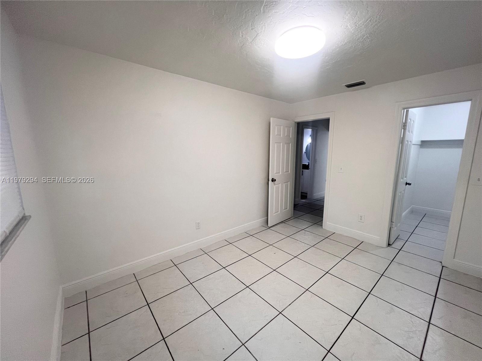 5600 Northwest 15th Street, Unit 9 Lauderhill, FL 33313 - Photo 5 of 7 a view of an empty room and window