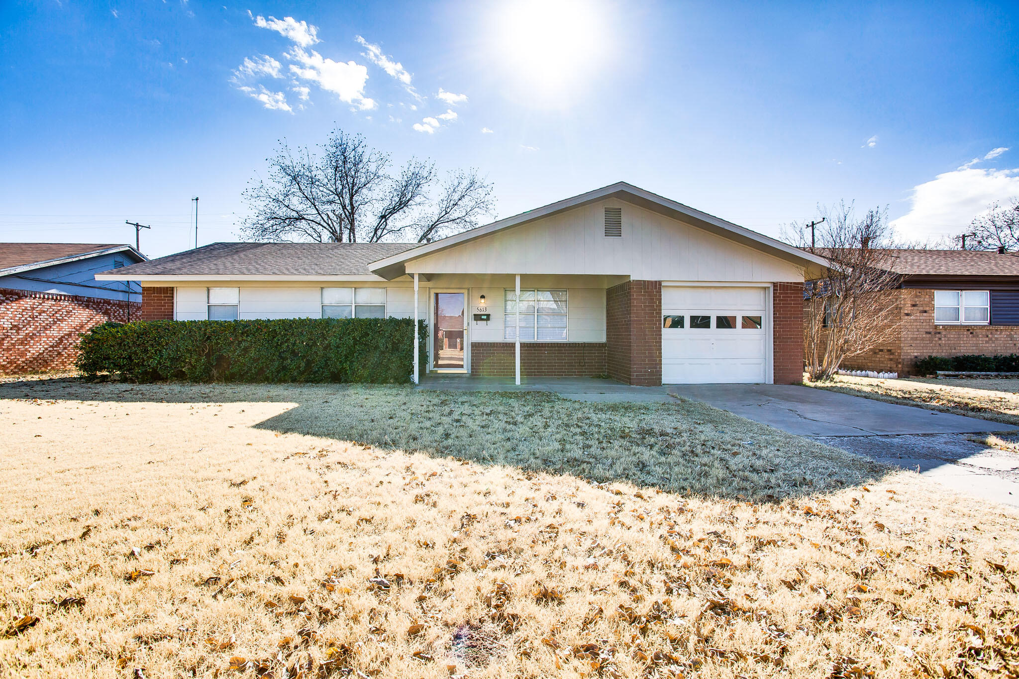 5613 16th Place Lubbock, TX 79416 - Photo 1 of 14 a front view of a house with a yard and garage