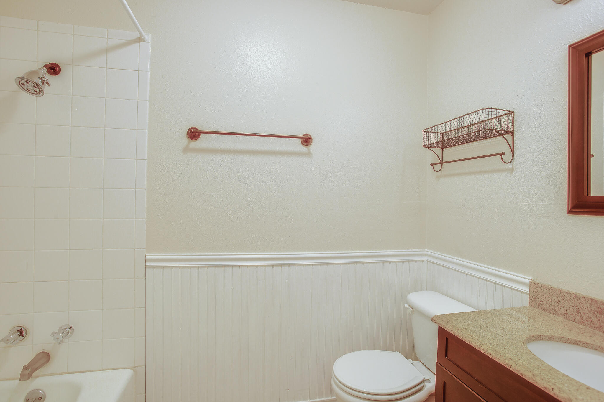 5613 16th Place Lubbock, TX 79416 - Photo 12 of 14 a bathroom with a toilet and a sink