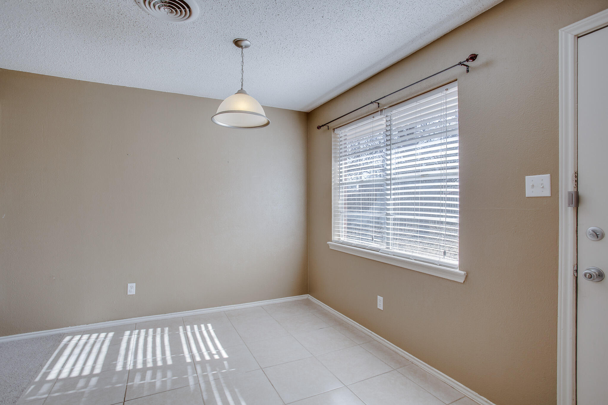 5613 16th Place Lubbock, TX 79416 - Photo 7 of 14 a view of an empty room with a window