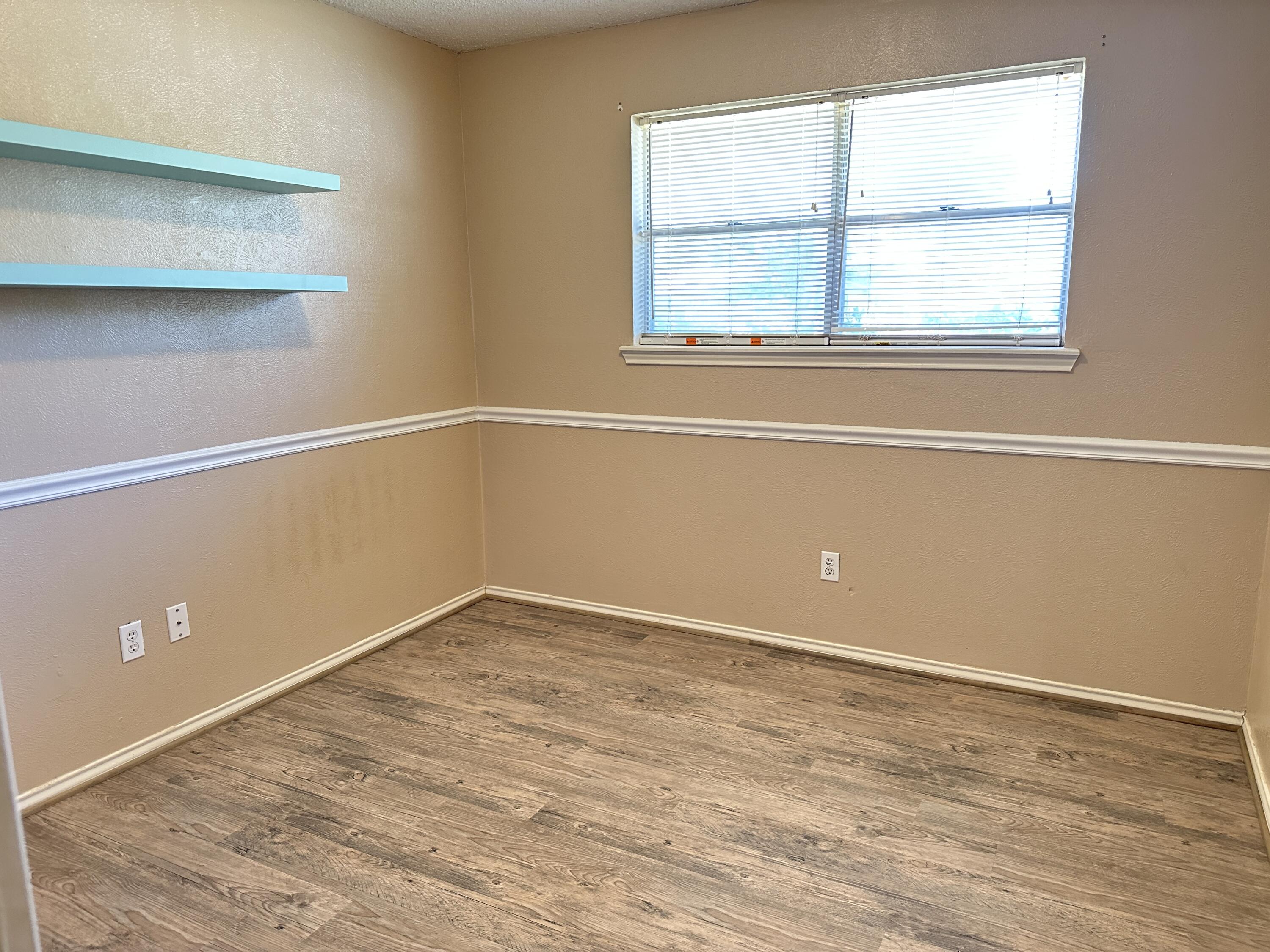 5613 16th Place Lubbock, TX 79416 - Photo 10 of 14 an empty room with a window