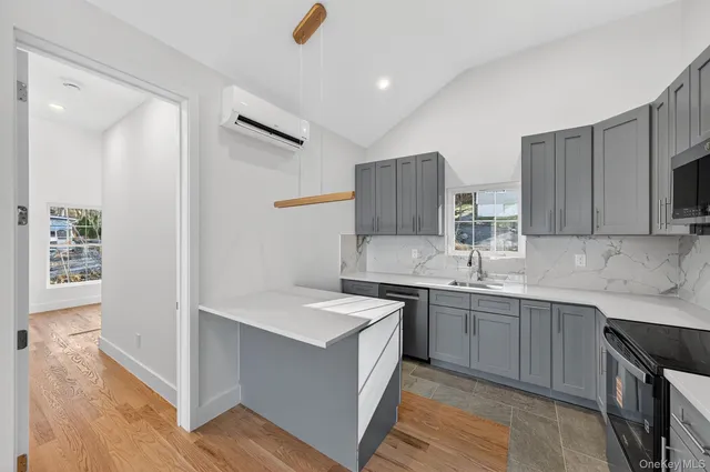 a kitchen with a refrigerator and a stove top oven