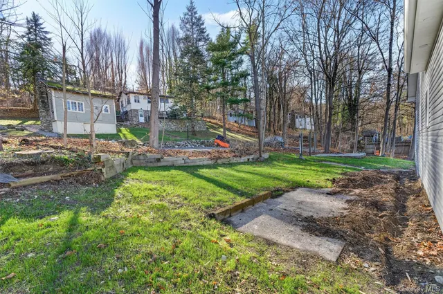 a view of backyard of house and trees