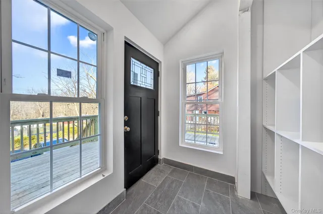 a view of an entryway with wooden floor and door
