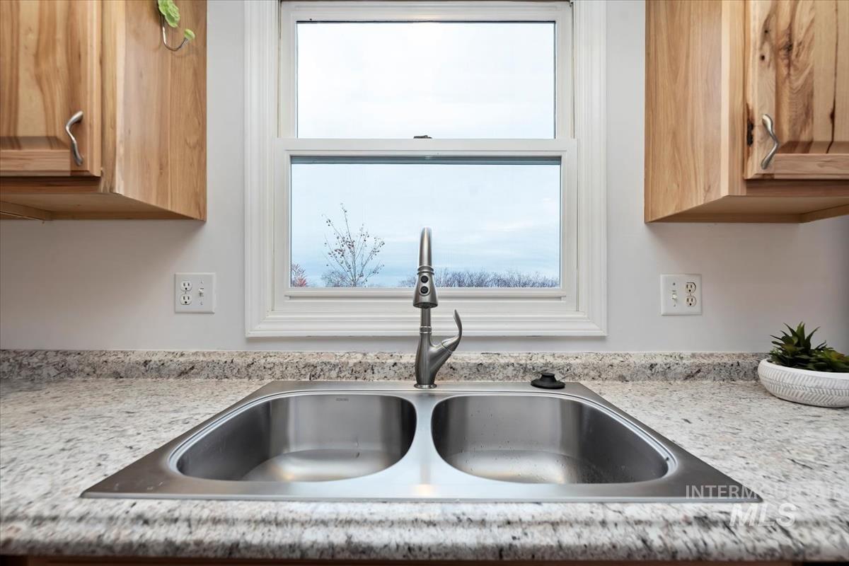 7790 Ustick Road Nampa, ID 83687 - Photo 14 of 41 Kitchen view of light stone counters