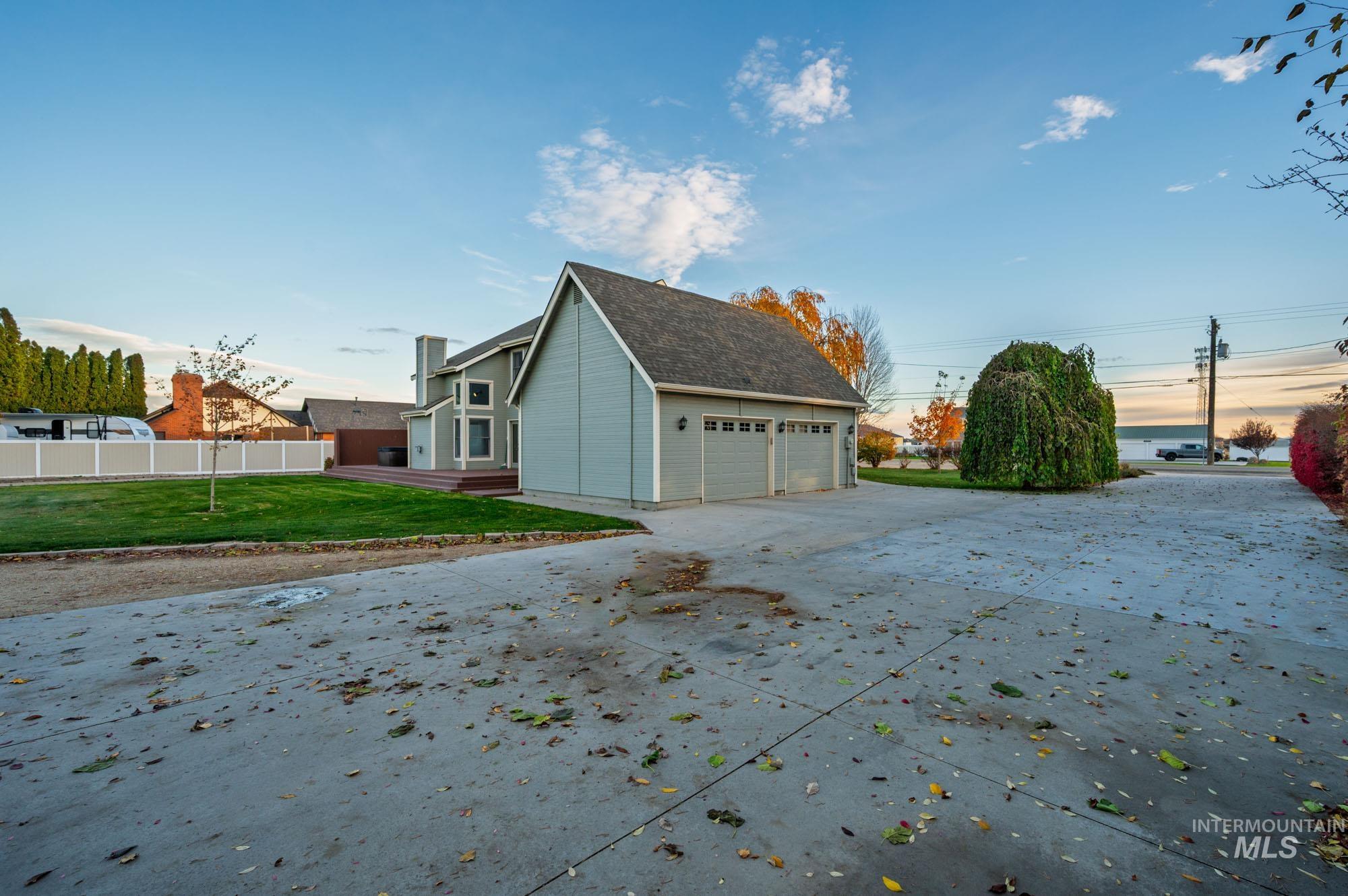 7790 Ustick Road Nampa, ID 83687 - Photo 30 of 41 View of home's exterior with a garage and concrete driveway