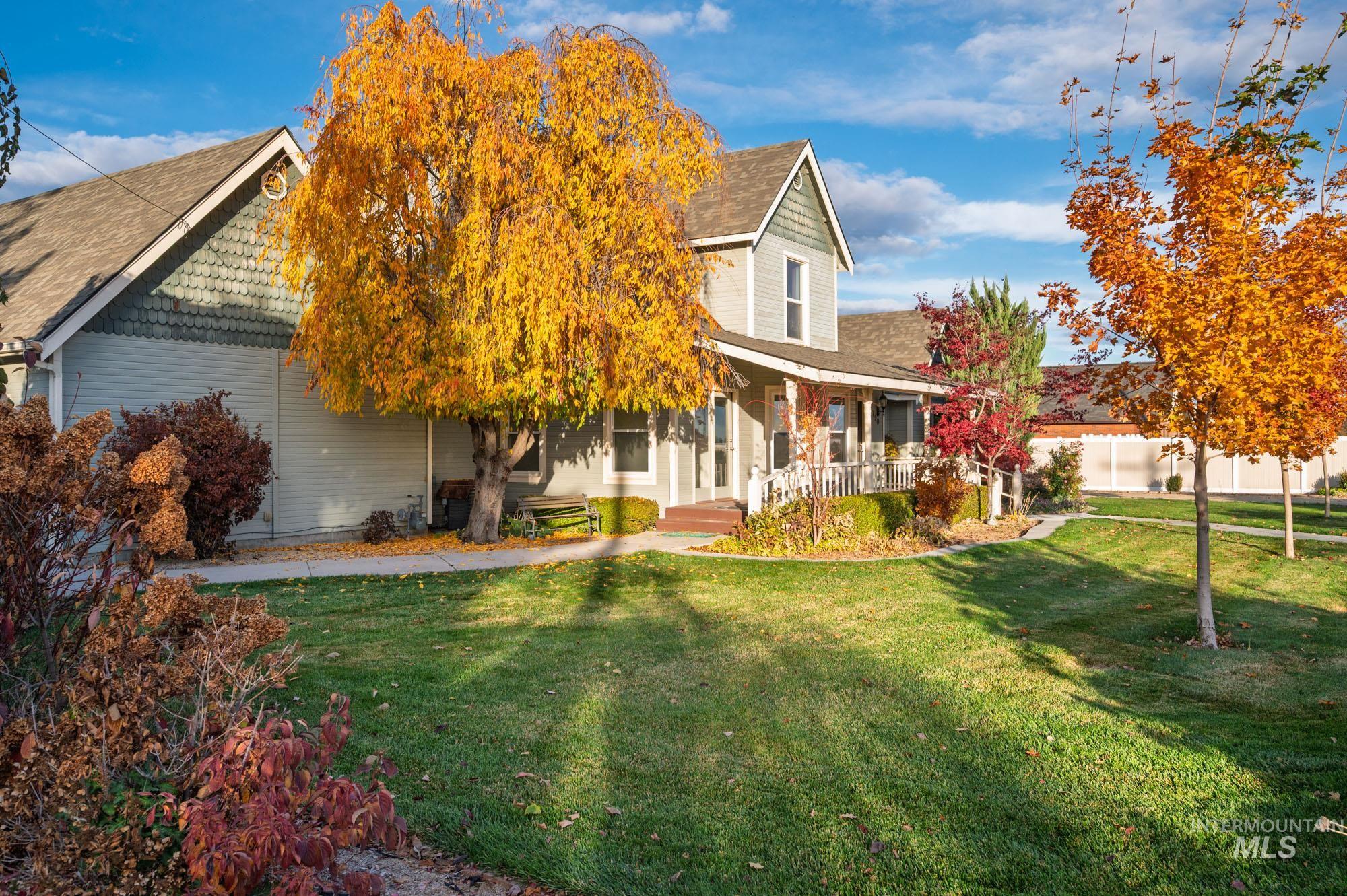 7790 Ustick Road Nampa, ID 83687 - Photo 37 of 41 View of front of house with a front lawn, a porch, and roof with shingles