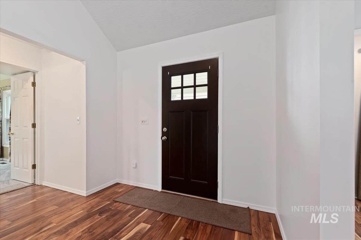 7790 Ustick Road Nampa, ID 83687 - Photo 5 of 41 Foyer featuring dark wood finished floors and lofted ceiling