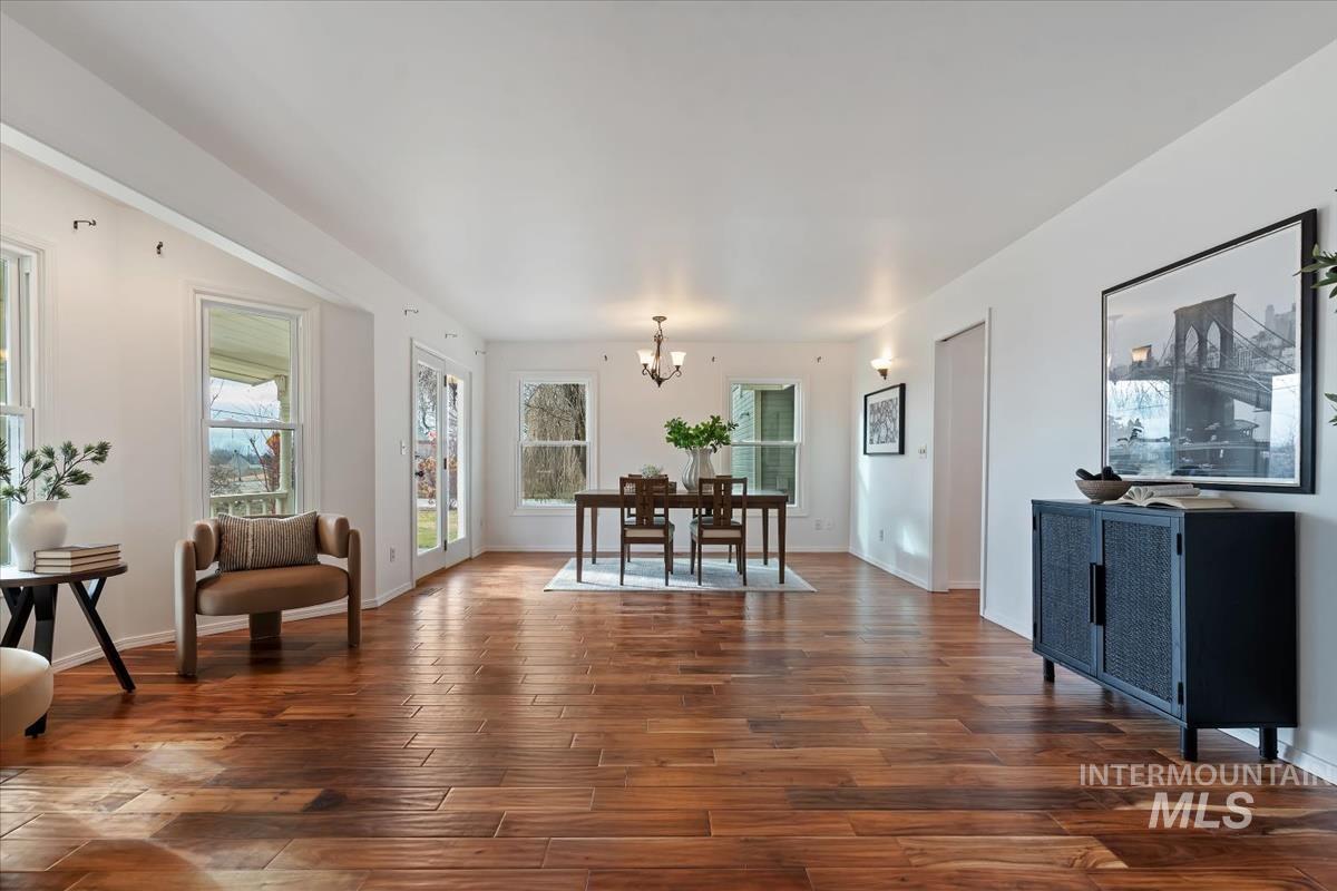 7790 Ustick Road Nampa, ID 83687 - Photo 9 of 41 Dining area featuring dark wood-type flooring and a chandelier