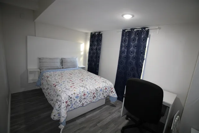 a bedroom with a bed and a chair