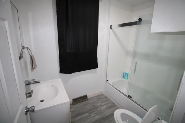 a bathroom with a sink toilet and shower