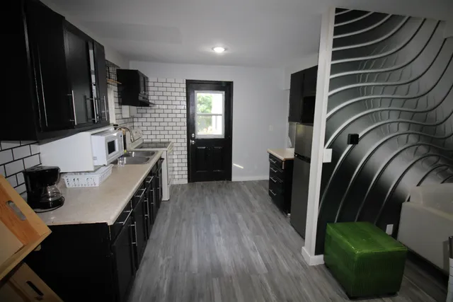 a kitchen with a sink appliances and cabinets