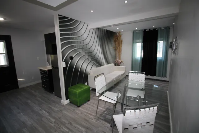 a view of entryway and hall with wooden floor