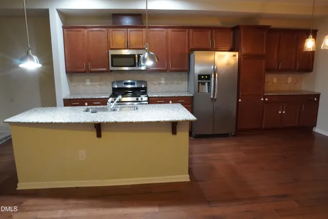 a kitchen with a sink and refrigerator